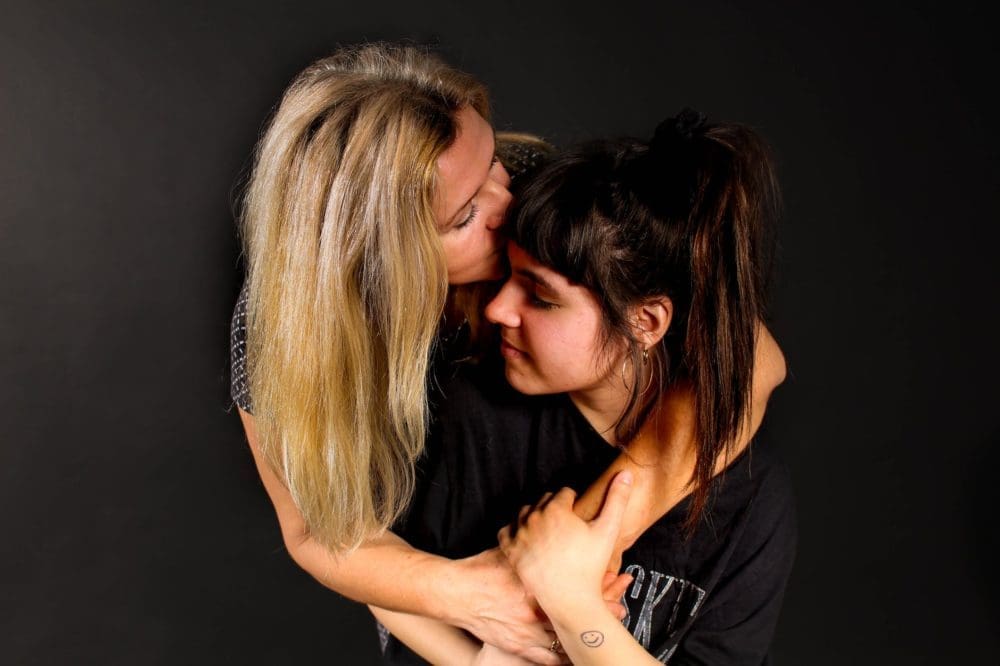 woman kissing girl on forehead